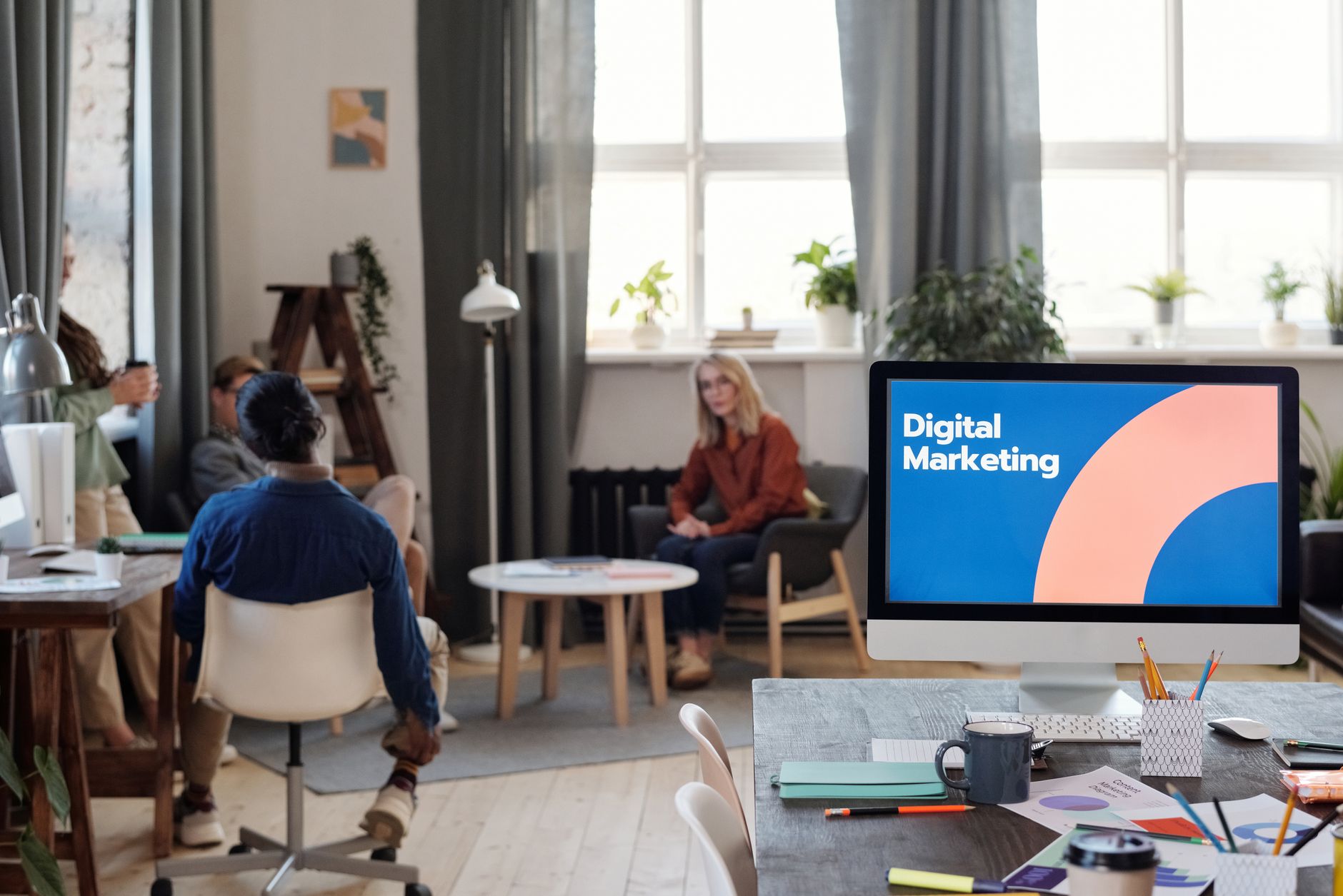 A diverse team engages in a digital marketing meeting in a stylish office setting. — Fastest WordPress Hosting : Overview