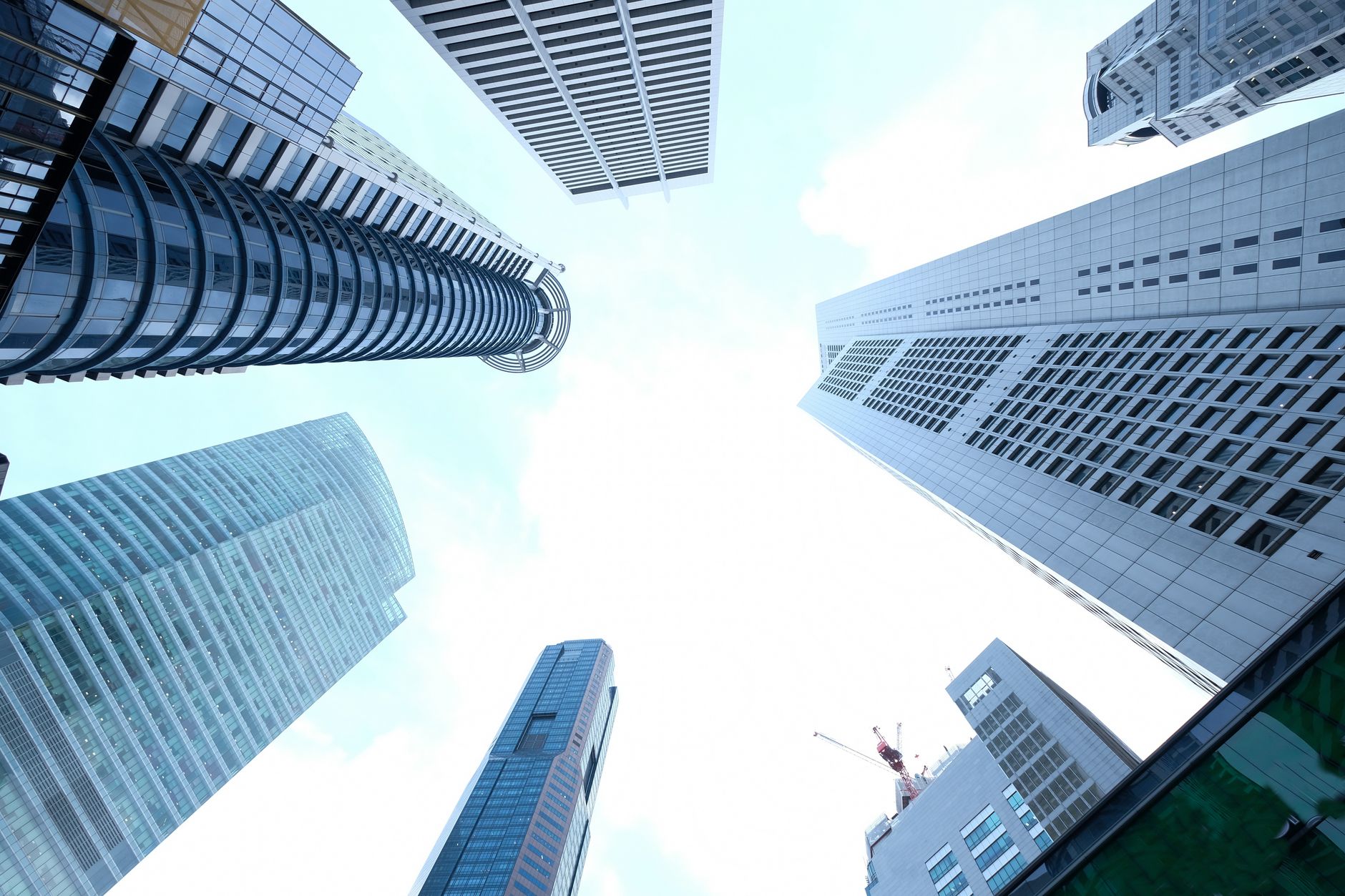 A striking upward view of various skyscrapers in an urban setting against a clear sky. — Features of Techvision Accounting So