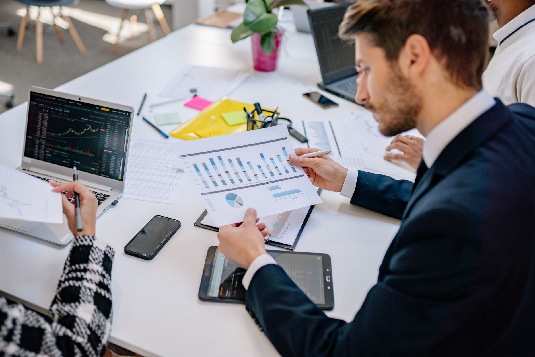 Business team reviewing graphs and data in an office setting. — Get the renter's insurance you need