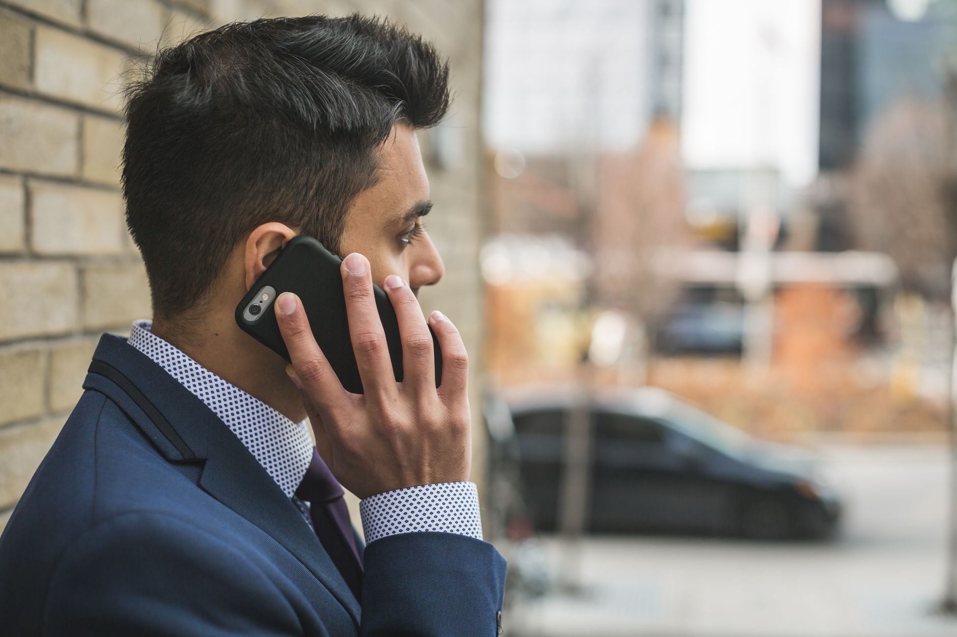 Professional man in suit making a phone call outside in city setting. — How Fast Ethernet And Gigabit Ethernet Technologies W
