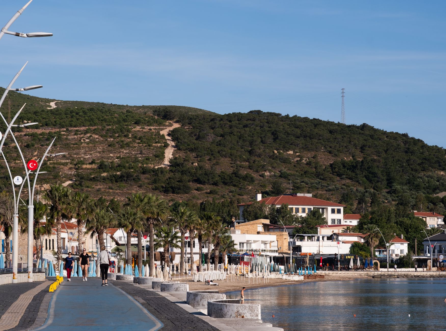 A beautiful coastal promenade in Foça, İzmir with a hillside backdrop, perfect for a relaxing stroll. — How to Enable Two-Fac