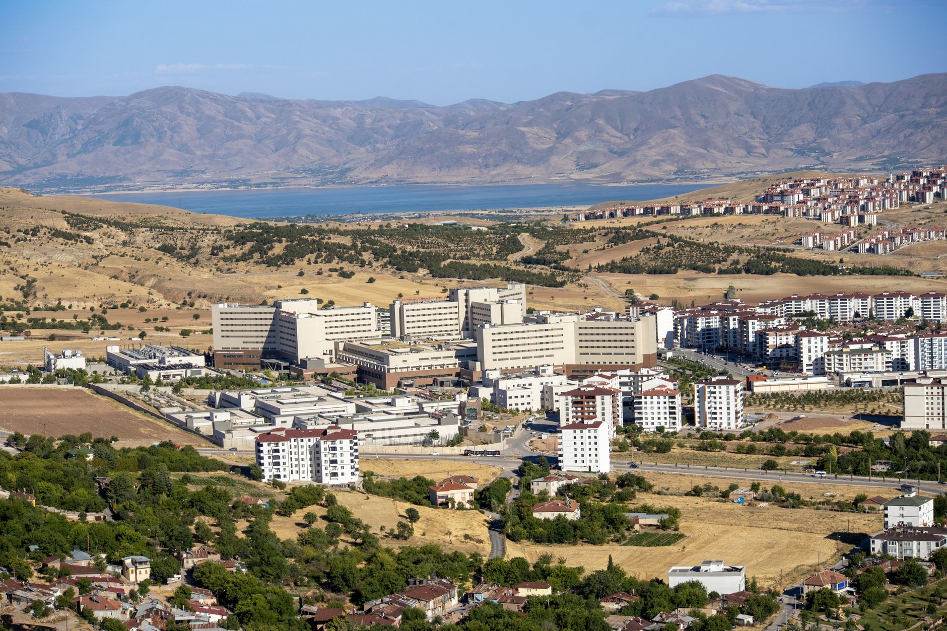 Stunning aerial photograph capturing the expansive cityscape of Elâzığ, Türkiye, with distant mountains. — How to Perform Onl