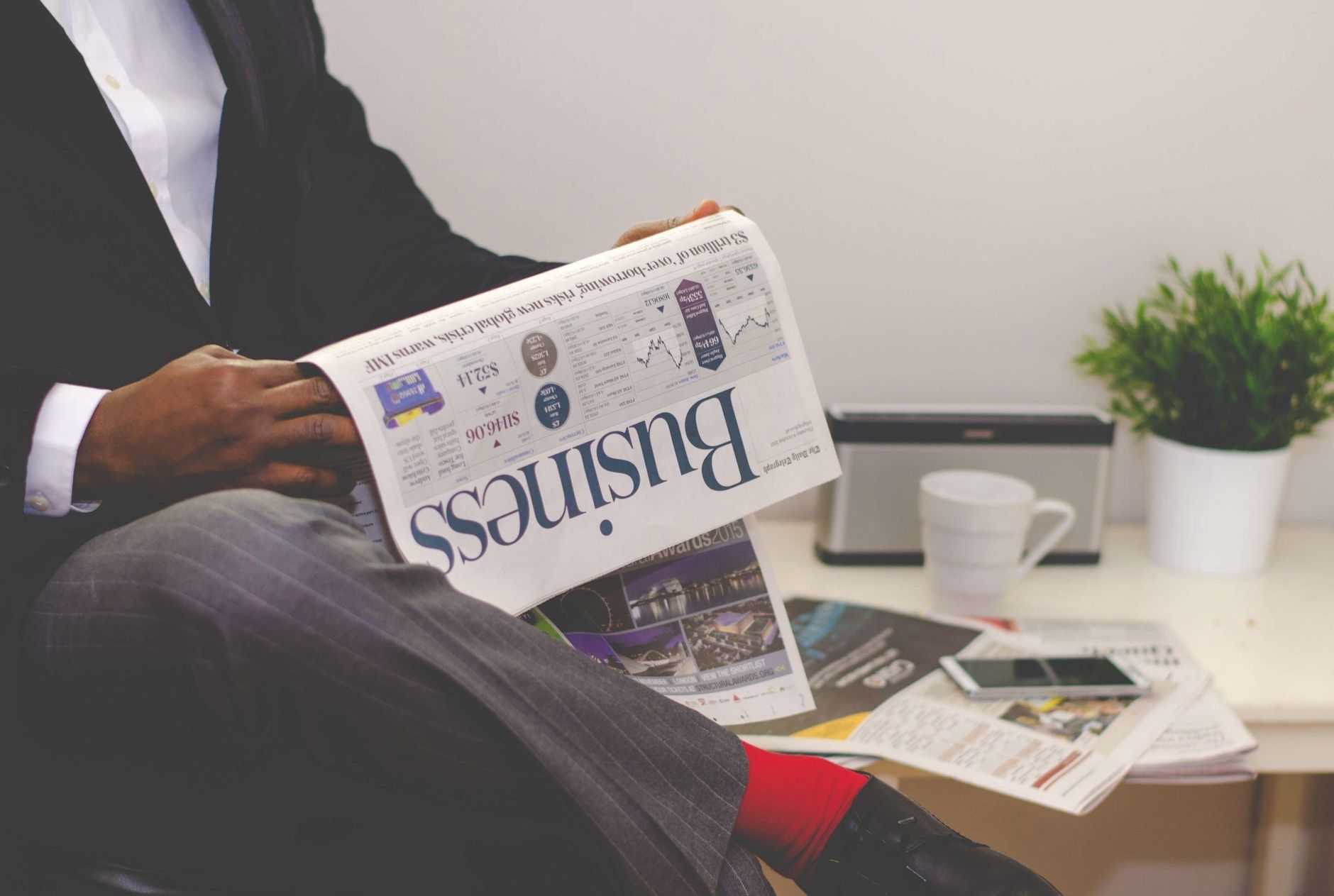 Businessman reading a financial newspaper at a desk, highlighting finance and commerce theme. — How to use digital marketing