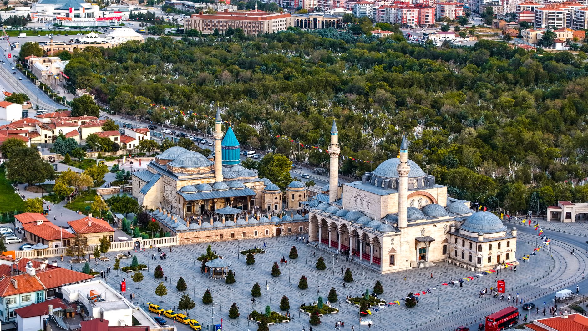 Vibrant aerial view of the iconic Mevlana Museum located in Konya, Türkiye, surrounded by lush greenery. — Make the Most Out