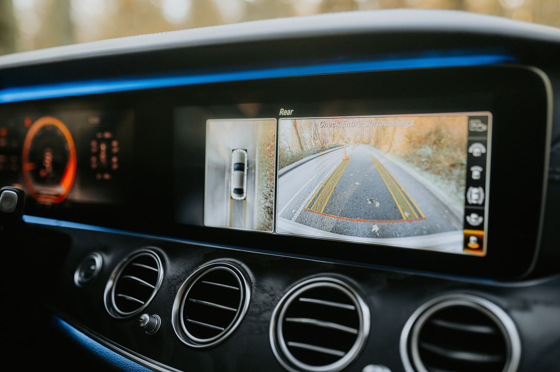 Close-up of a car dashboard showcasing a rear-view camera display and modern electronics. — Sorts of CNC Machines and Tools