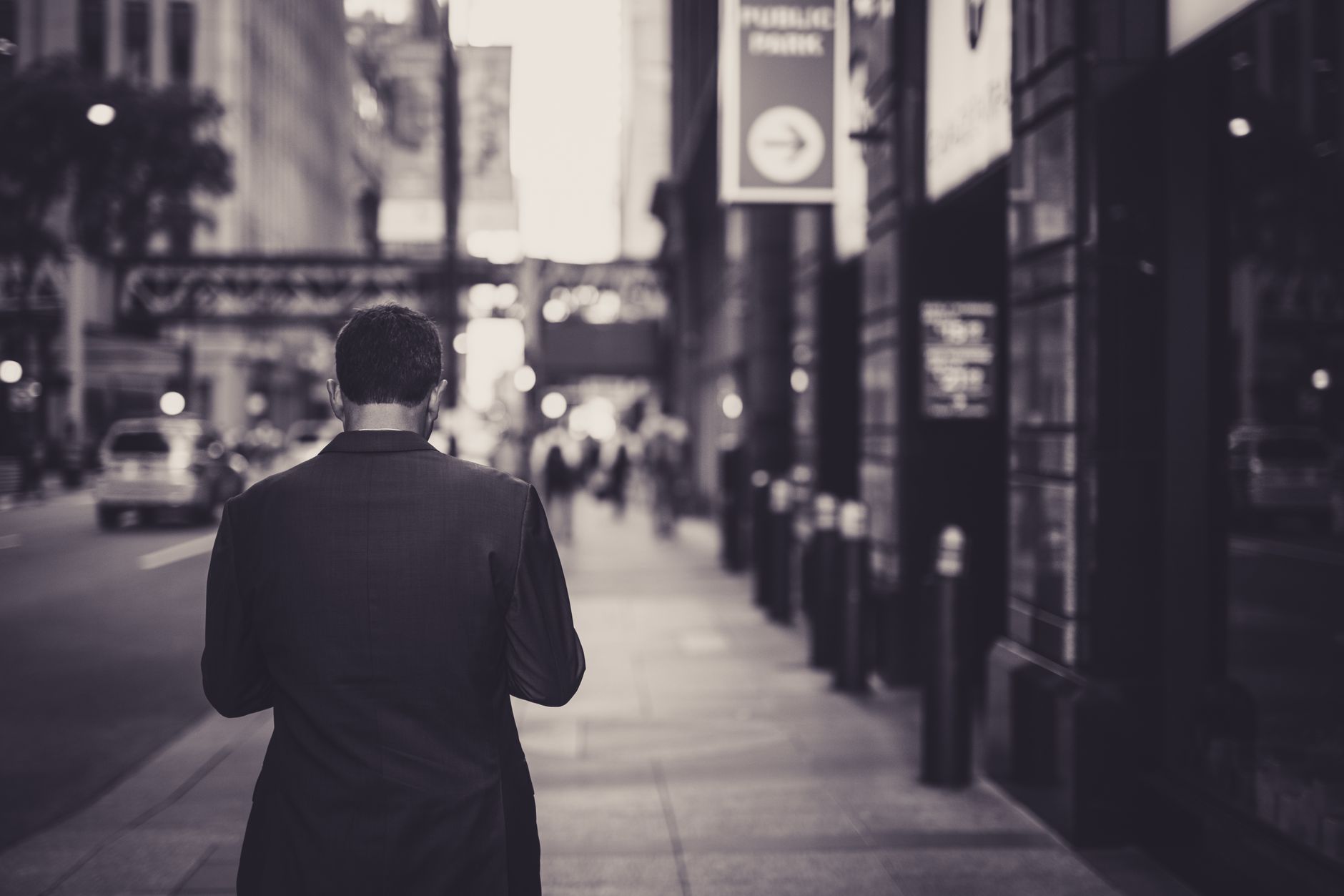 Man in a suit walking down a city street in a lonely, urban setting. — The restaurant business and it's future after covid19