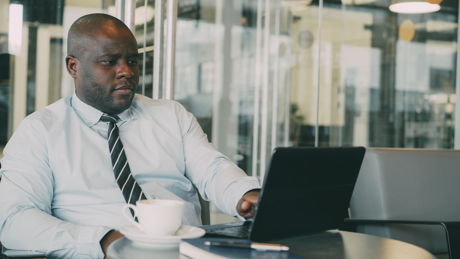Focused businessman uses laptop in stylish cafe, sipping coffee. Perfect for business or lifestyle themes. — Tips to get the