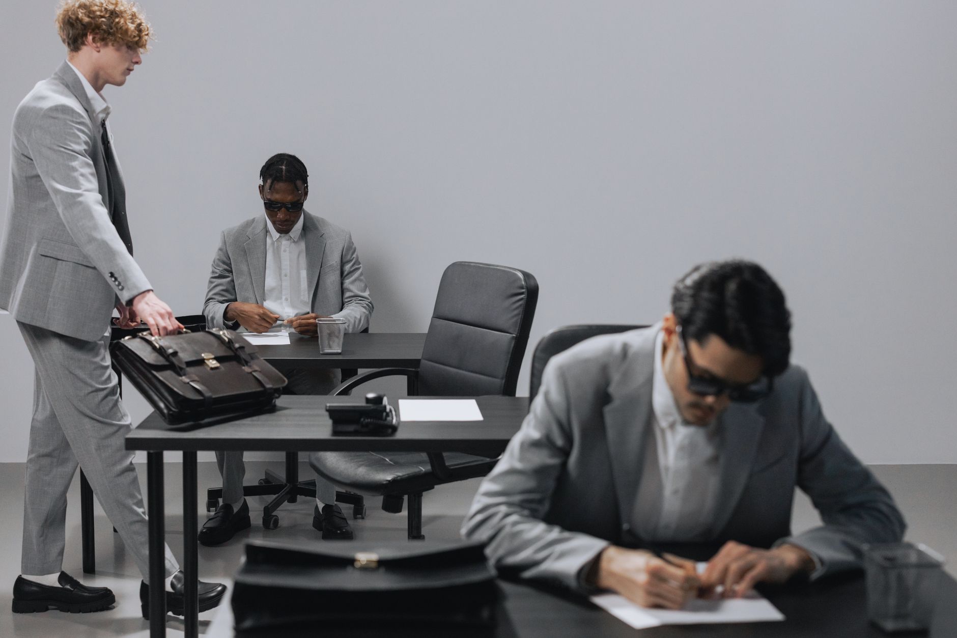 Business office with diverse employees in gray suits working at desks in an indoor setting. — Who are the competitors of Amaz
